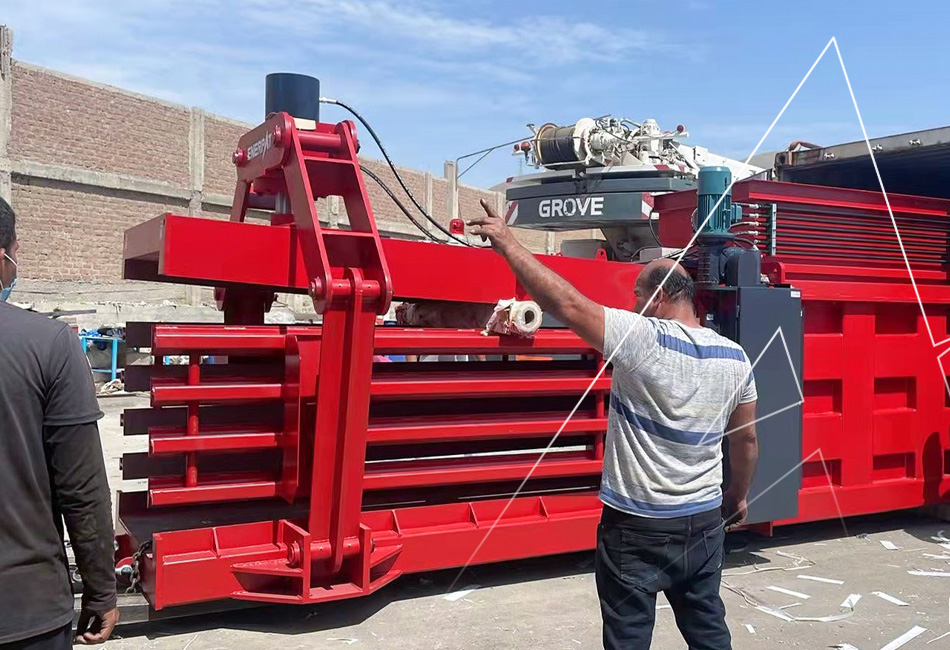 Automated horizontal baling press for cardboard recycling in a warehouse facility